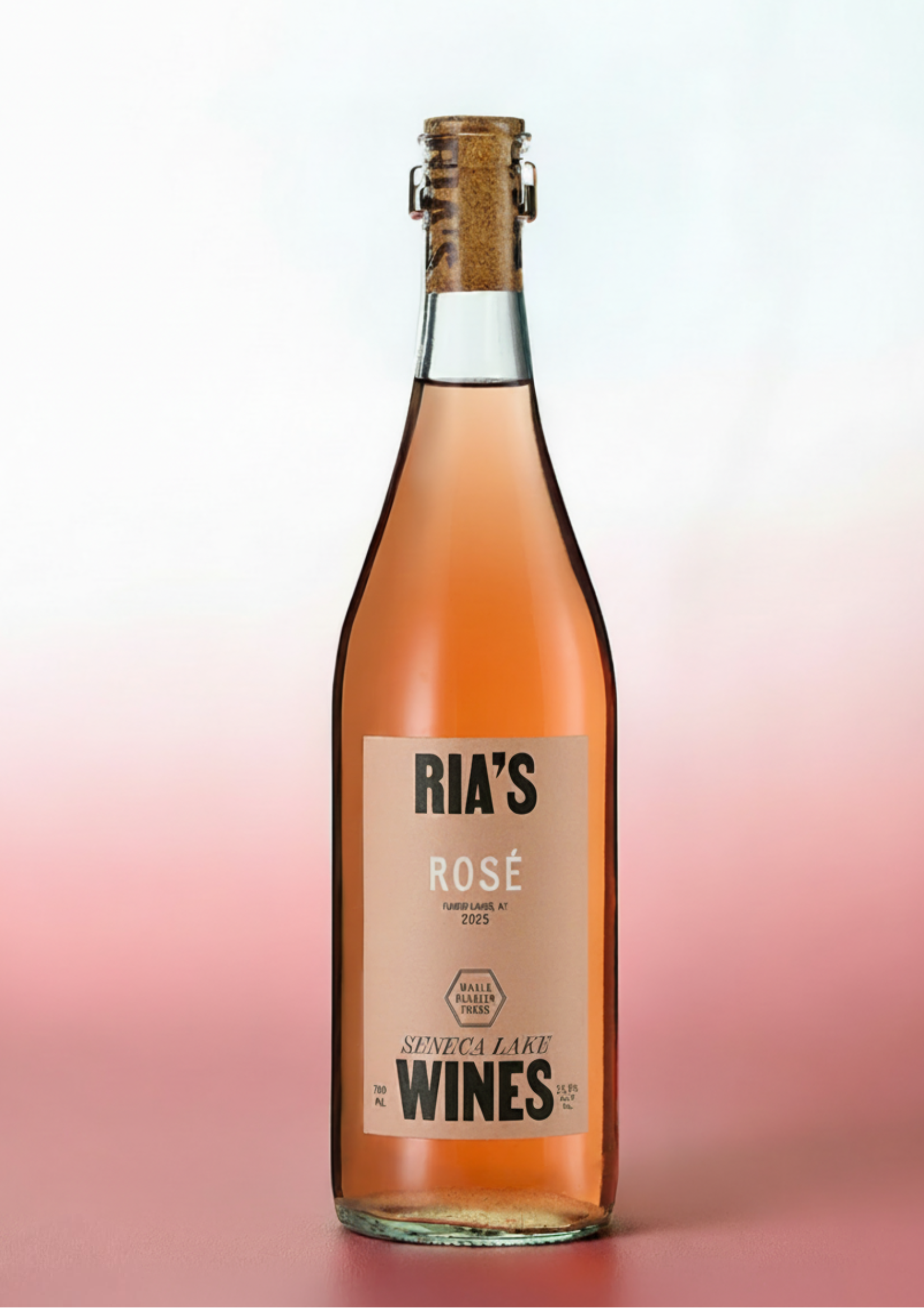 A bottle of Ria's Wines rosé, featuring a clear glass bottle filled with pinkish-rose liquid, a beige label, and a cork closure, set against a soft pink and white gradient background.